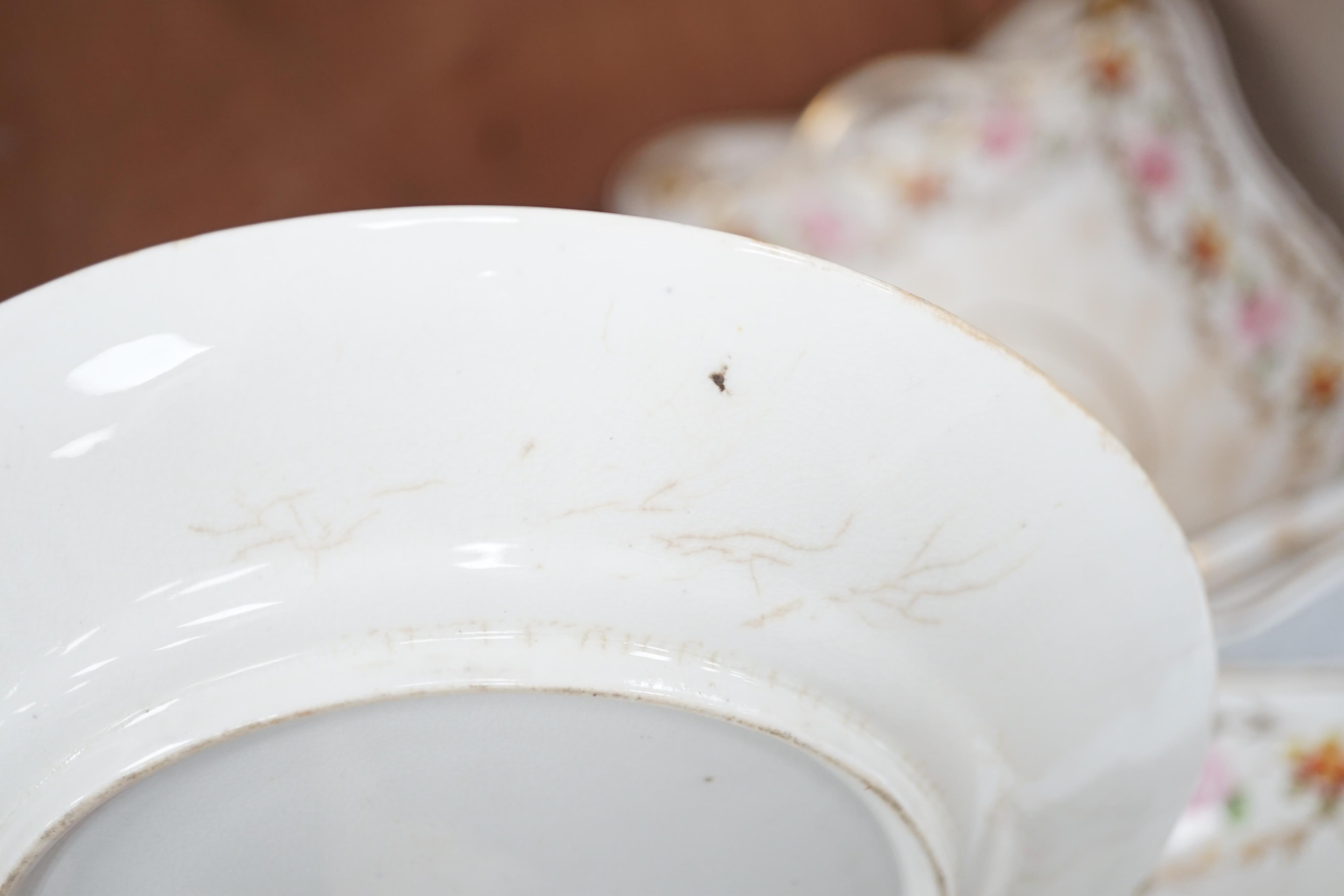 A sixteen piece Derby porcelain part dessert service, the borders painted with roses. Condition - some dishes and plates damaged or stained or crazed.